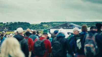 Still from the Aggreko end of year wrap: crowds walking towards the R&A pavilion at a golf championship.