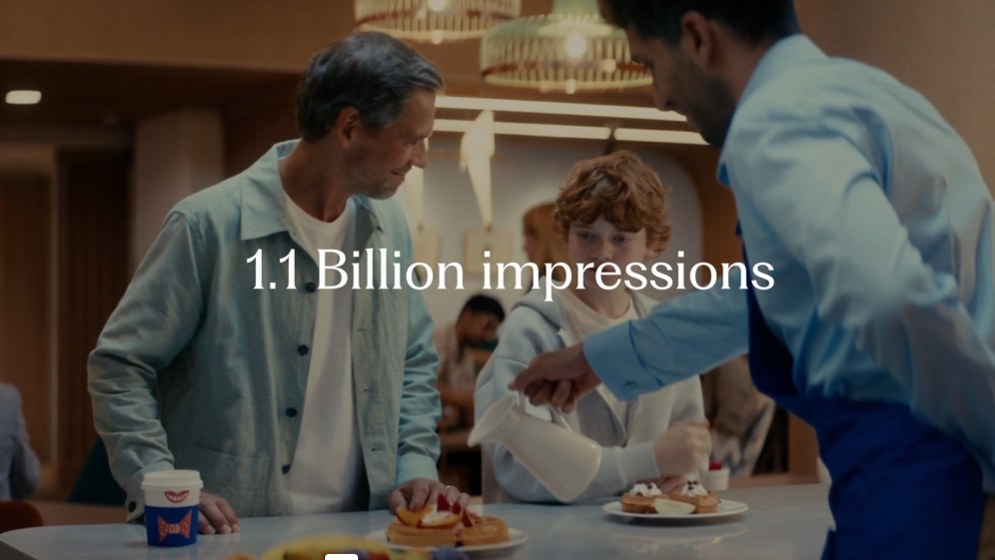 Still from the Hilton EMEA sizzle: a large roadside Hilton billboard in daylight.