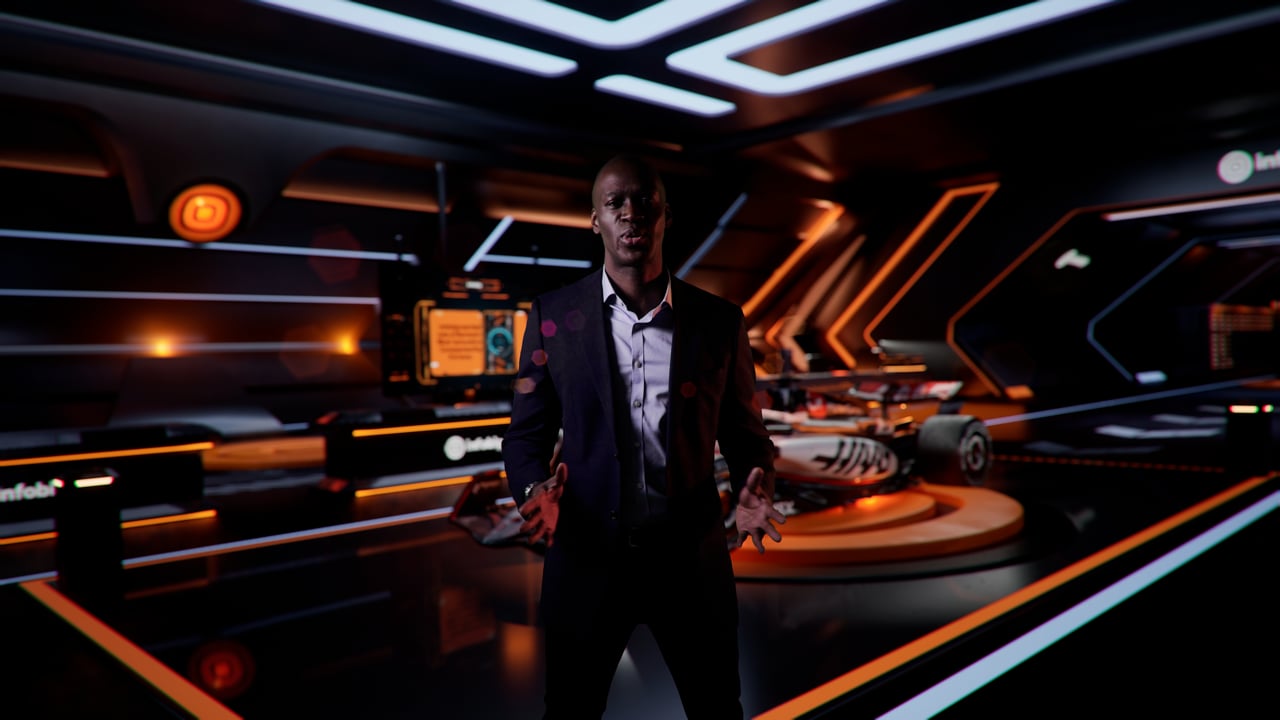 Still from the Infobip 2025 wrap up: a presenter standing in a virtual garage built in Unreal Engine.